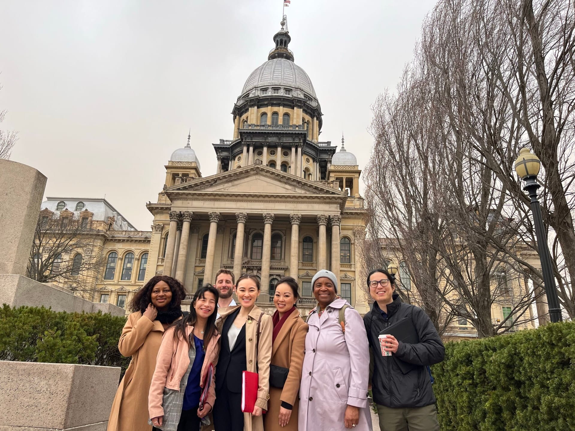 Group standing in front of the Illinois State Capitol.