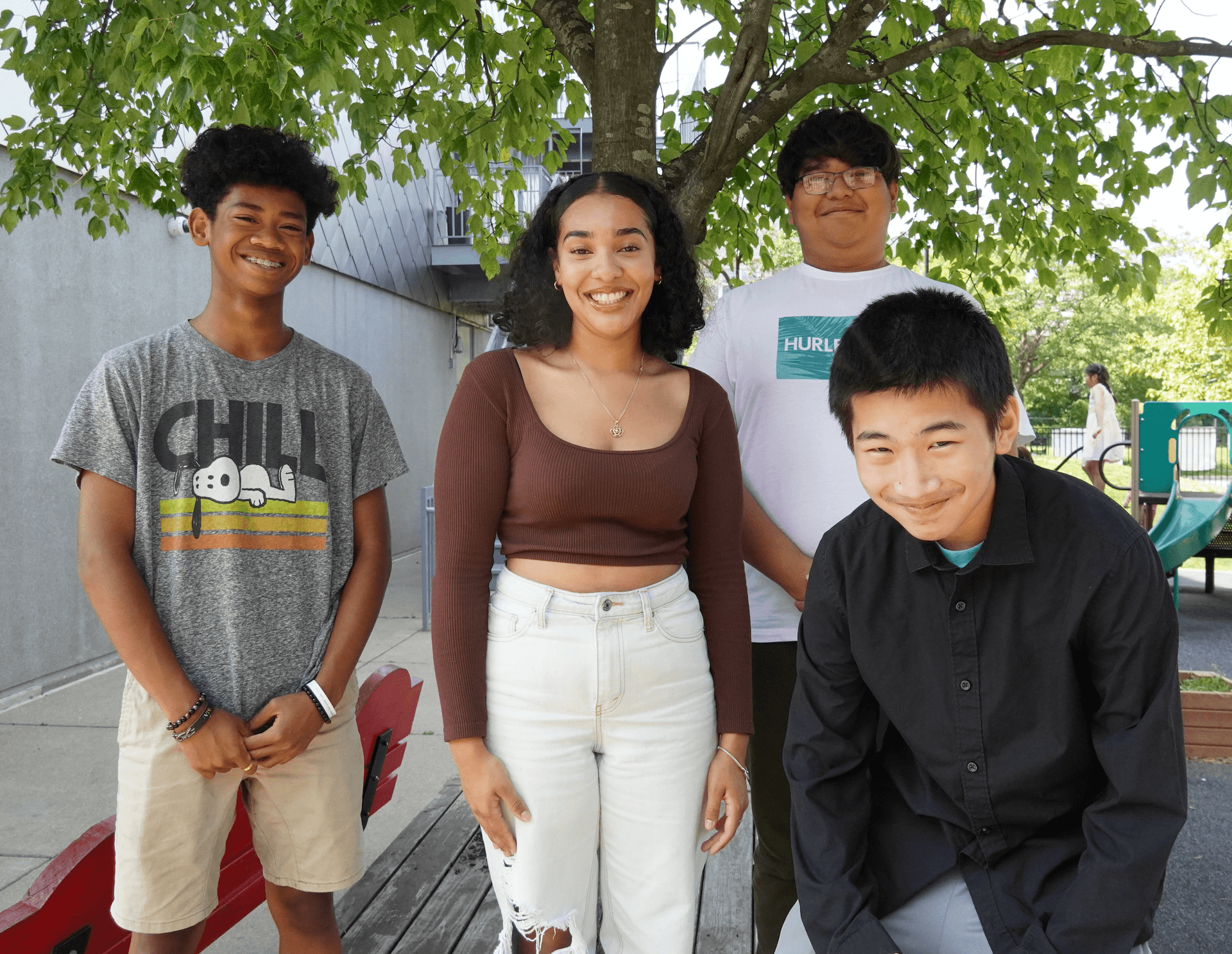 A group of young adults outside in summertime