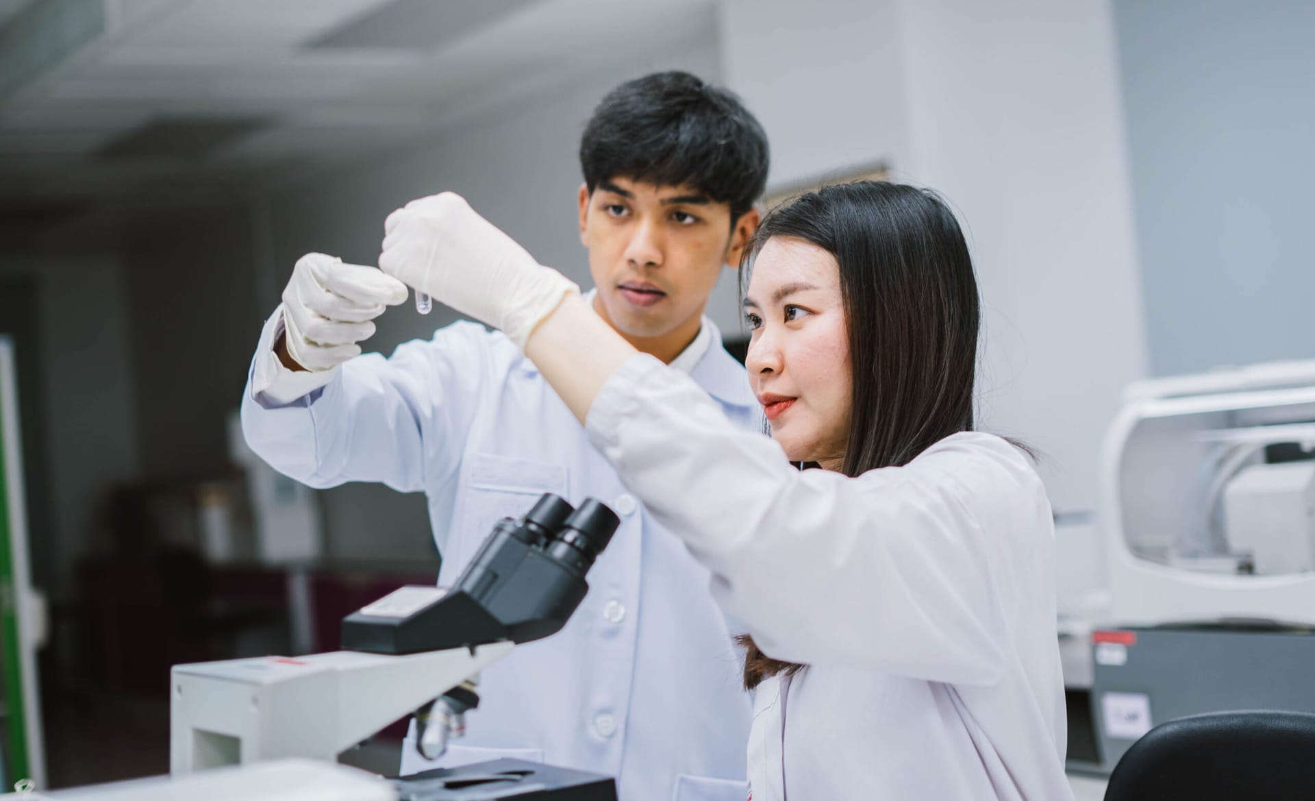 Medical students examining test tubes in laboratory