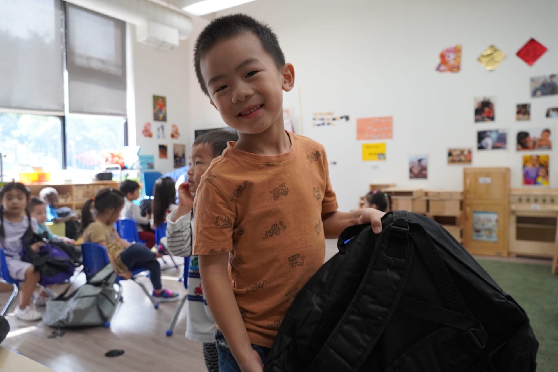 A preschool student in our Head Start program is excited to pick out their new backpack from the McDonald's team!