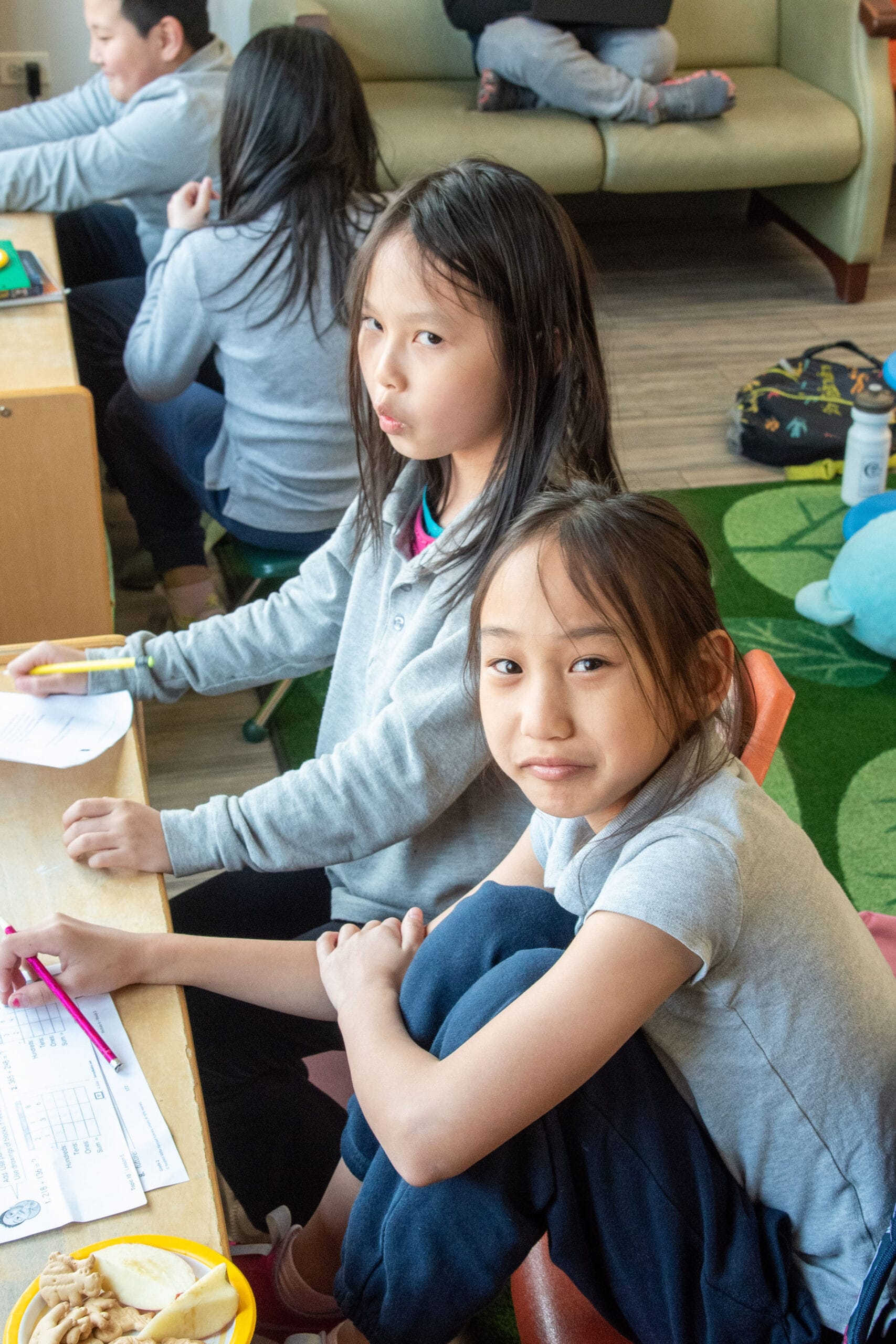 School-age students with worksheets.
