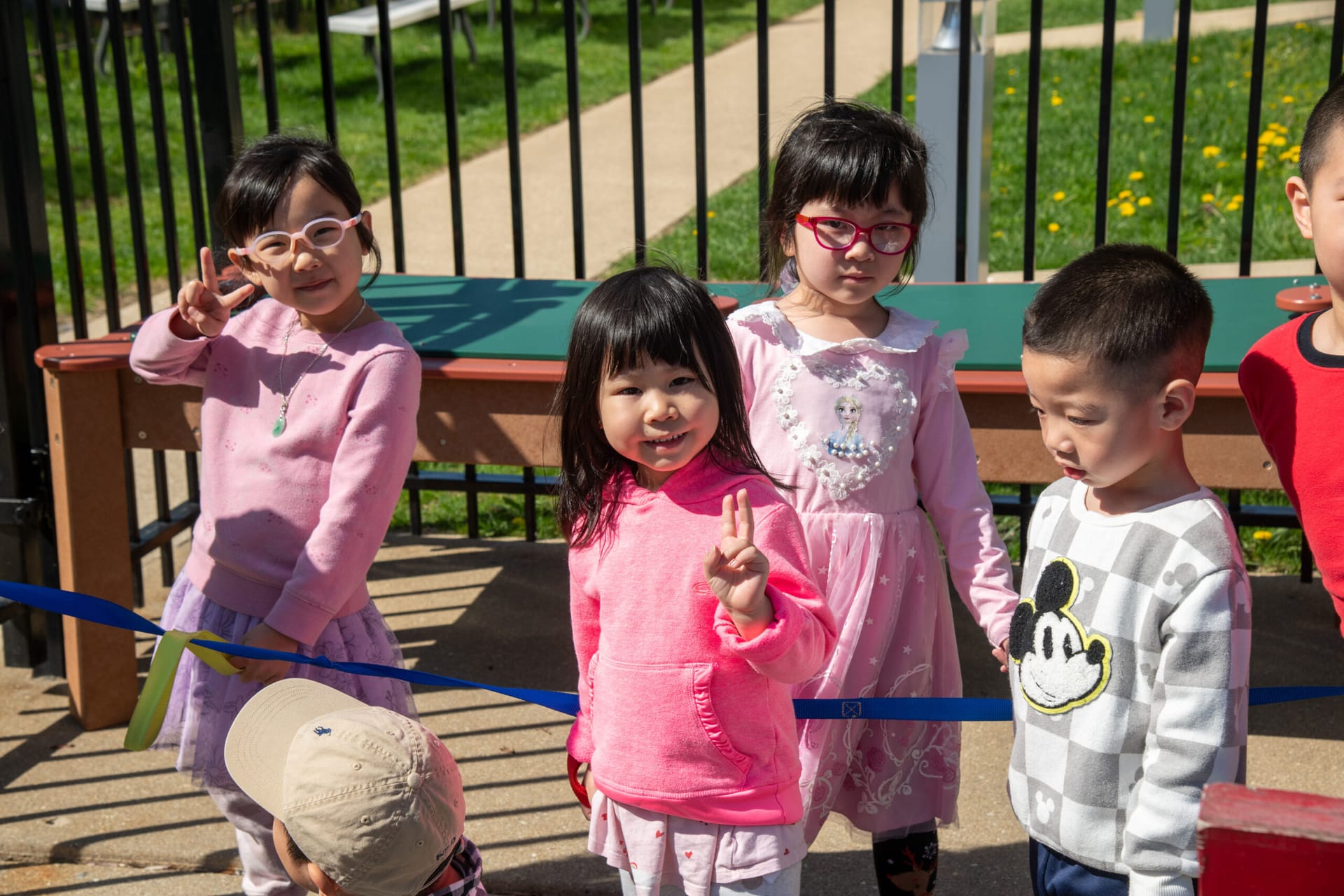 School-aged girls and boys playing outdoors.