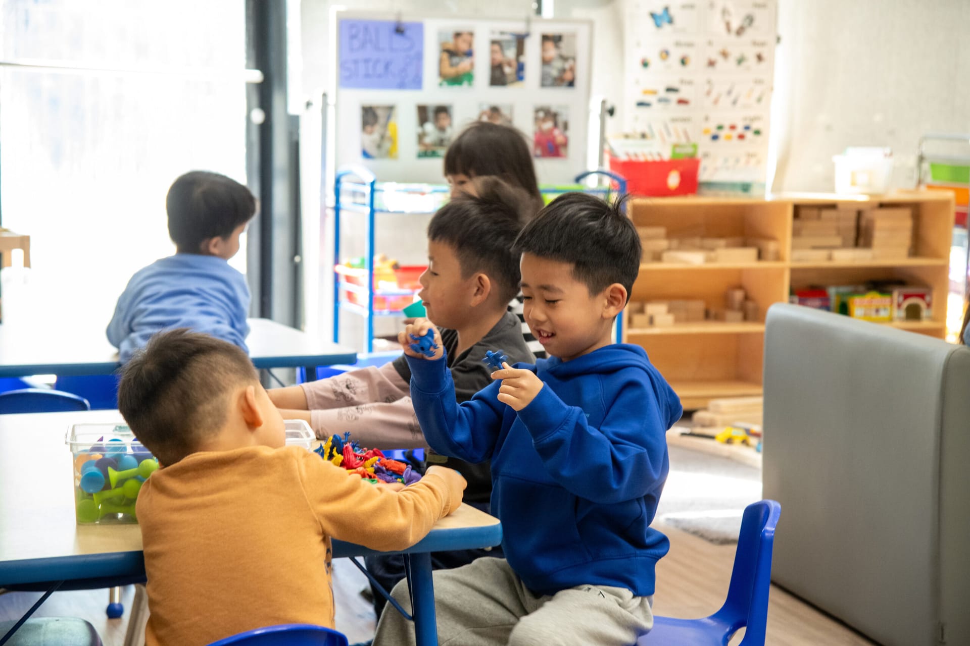 Small children playing puzzles and games at a table