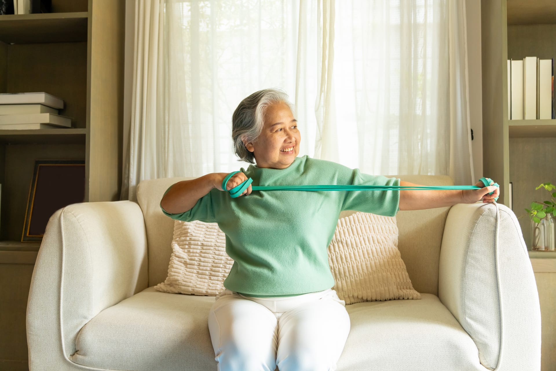 Asian senior exercising at home